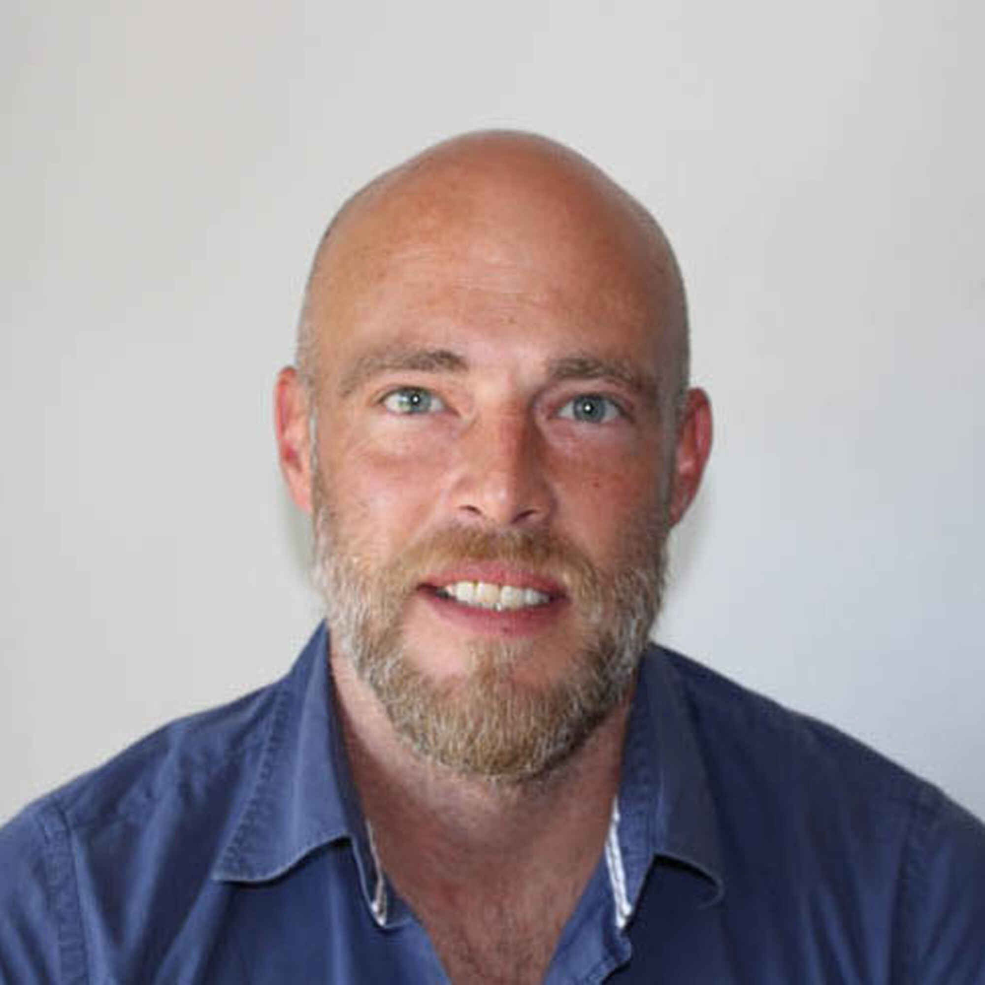 Matt Purkis, smiling man with beard wearing a dark blue shirt