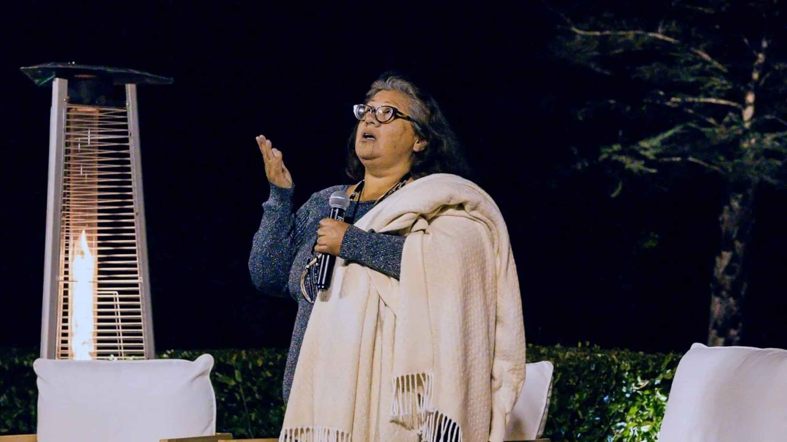 Woman speaking at an event about indigenous teachings and ancestral connection