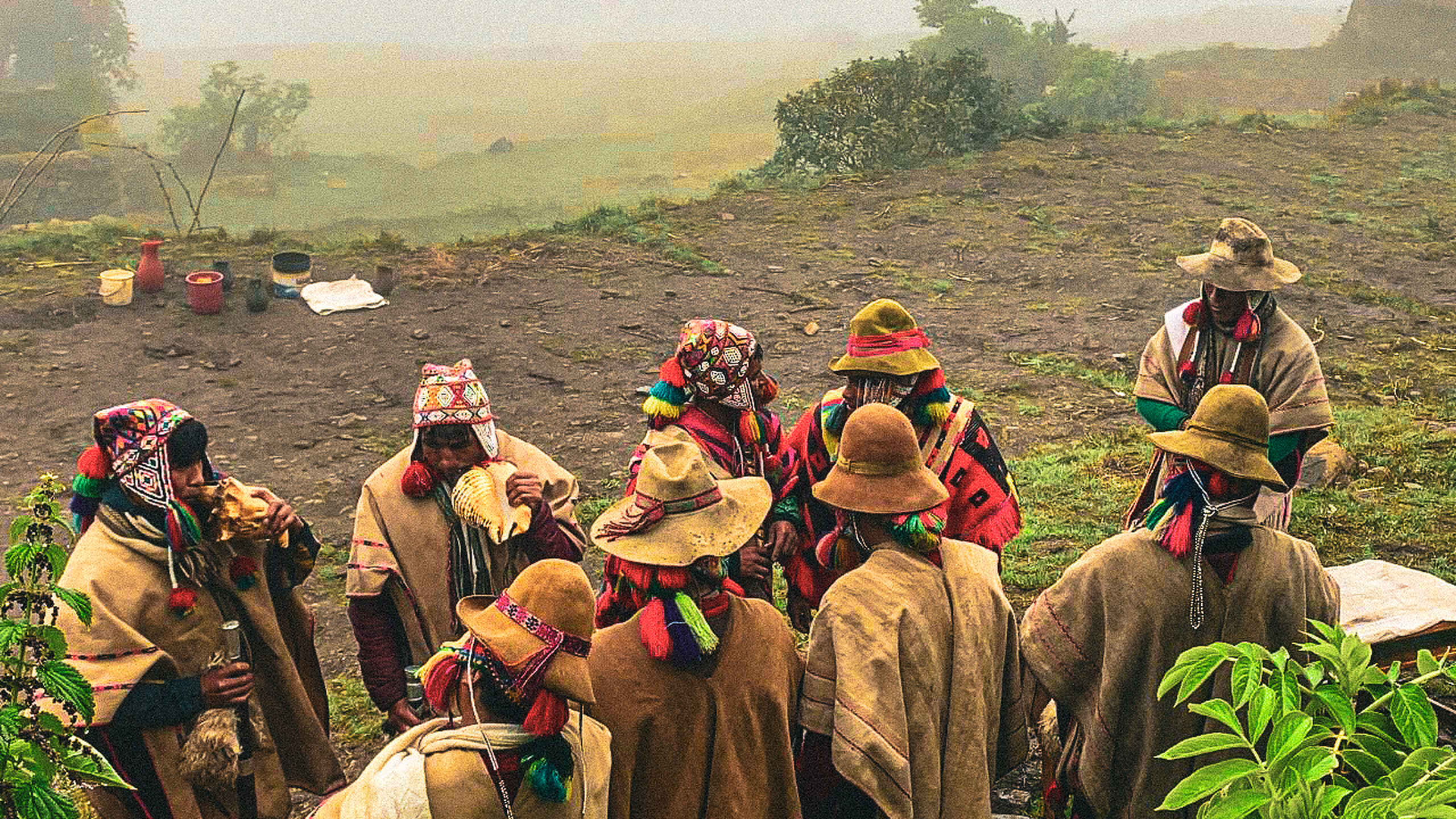 Indigenous community elders gather in a mountainous valley to share traditional knowledge and cultural practices