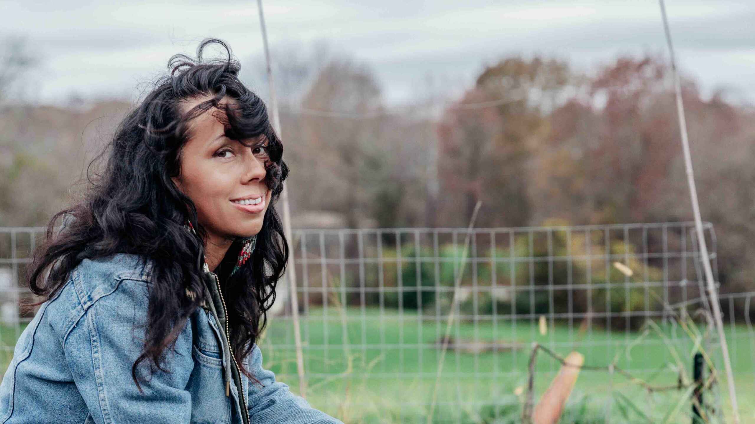 Woman harvesting fresh greens from a vegetable garden bed