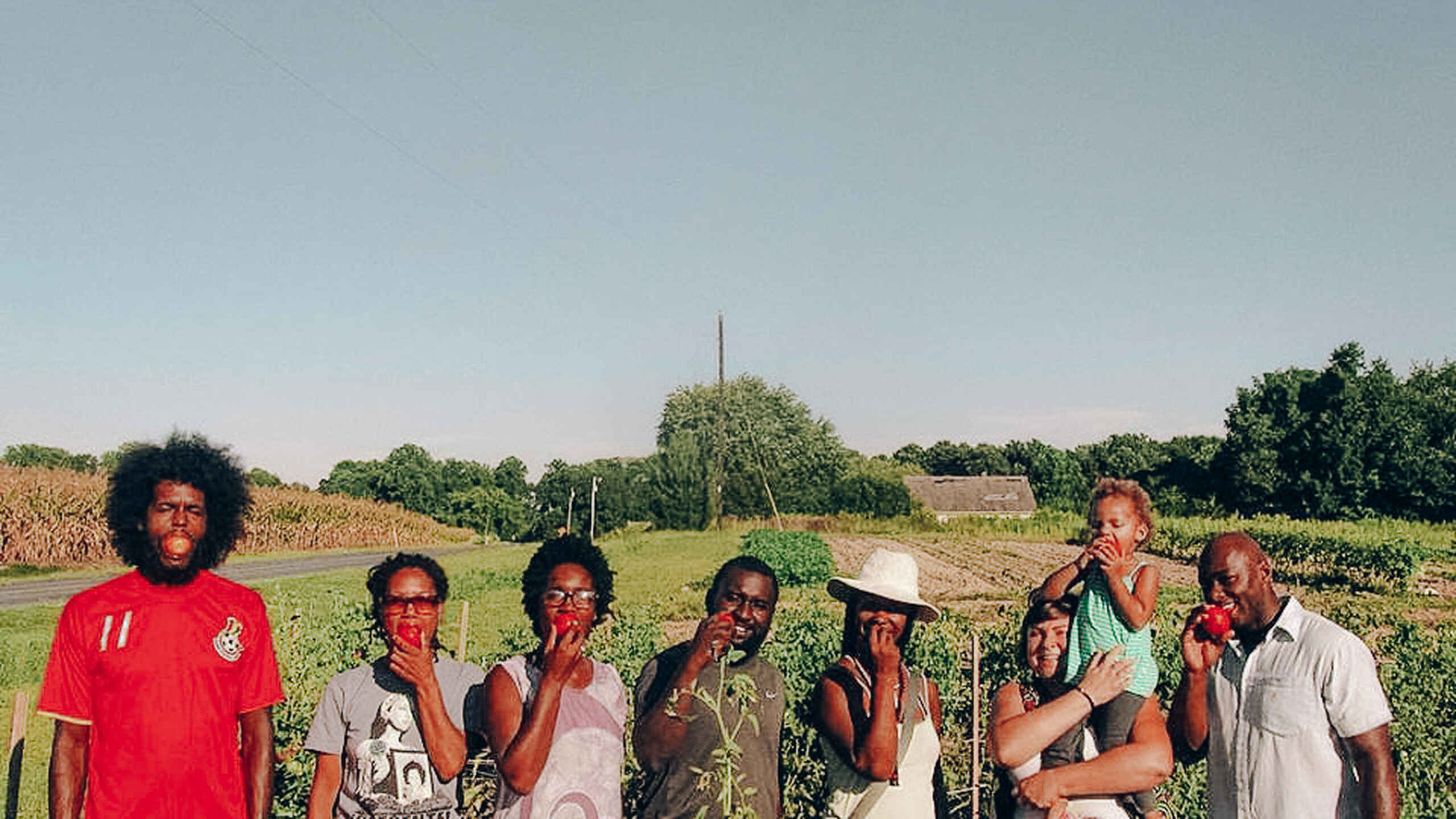 Black Dirt Farm Collective members pose together in a vegetable field