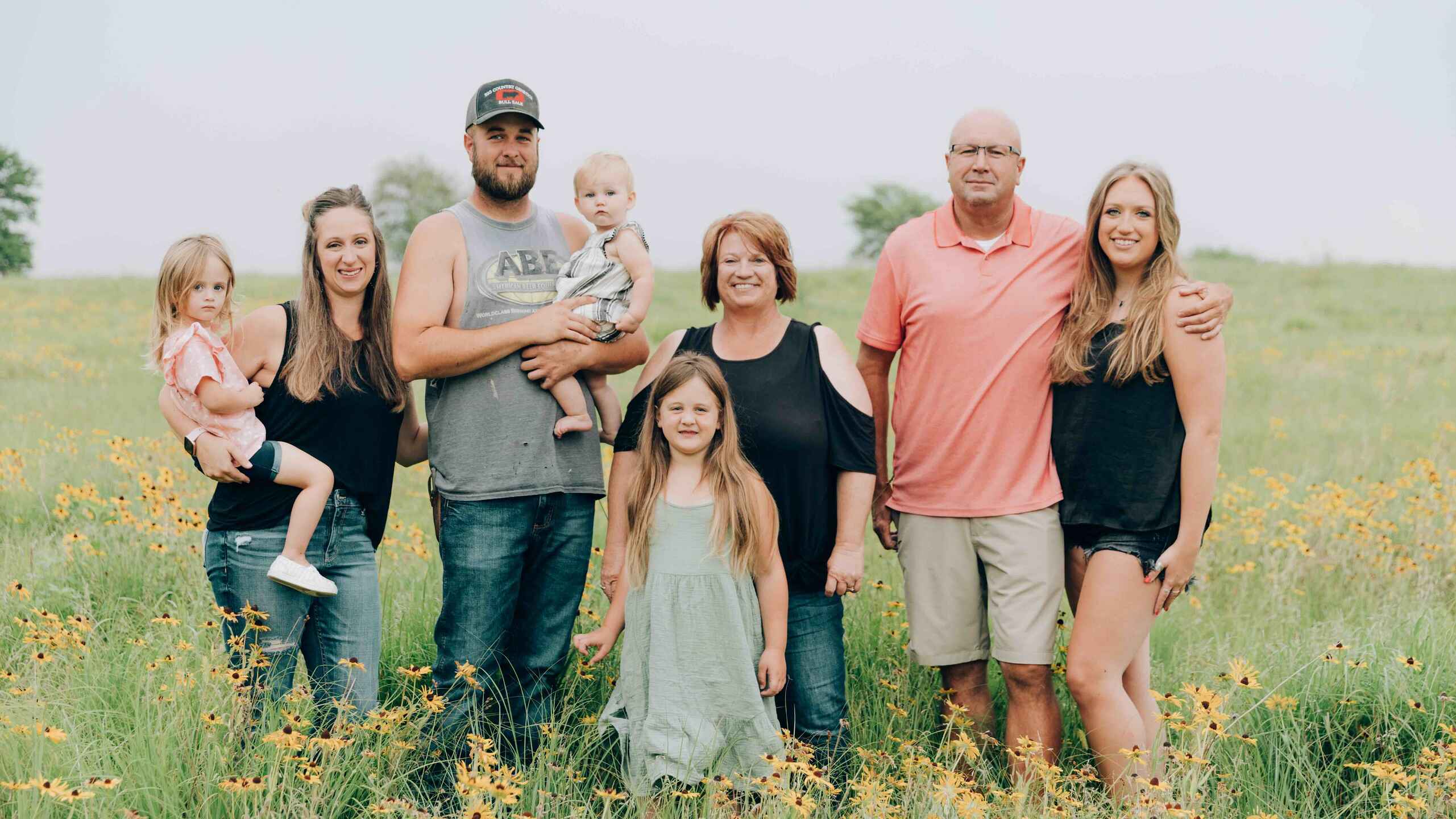 Del Ficke and family standing in a wildflower field