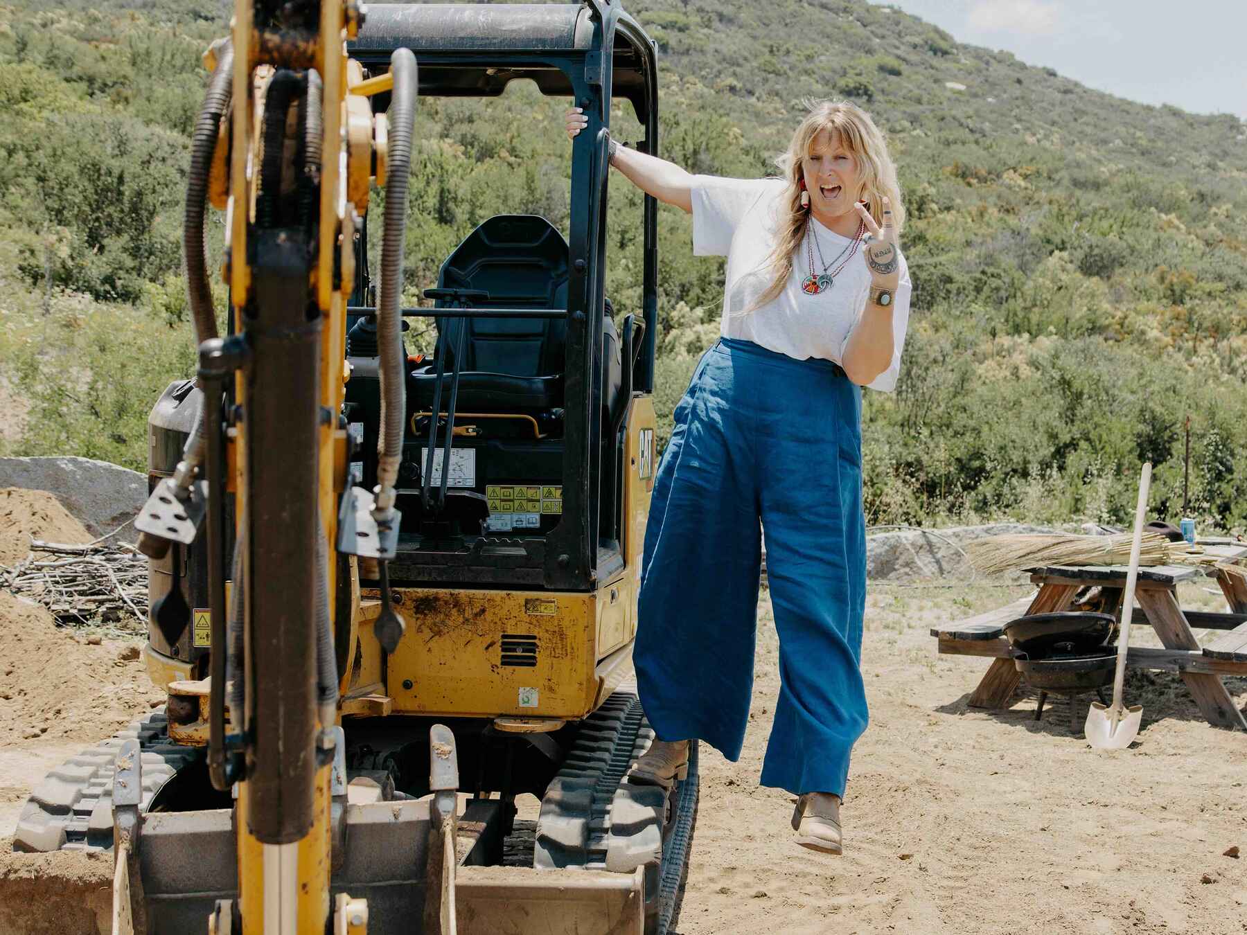 Lacey Cannon operates a compact excavator on her regenerative farm in the California foothills