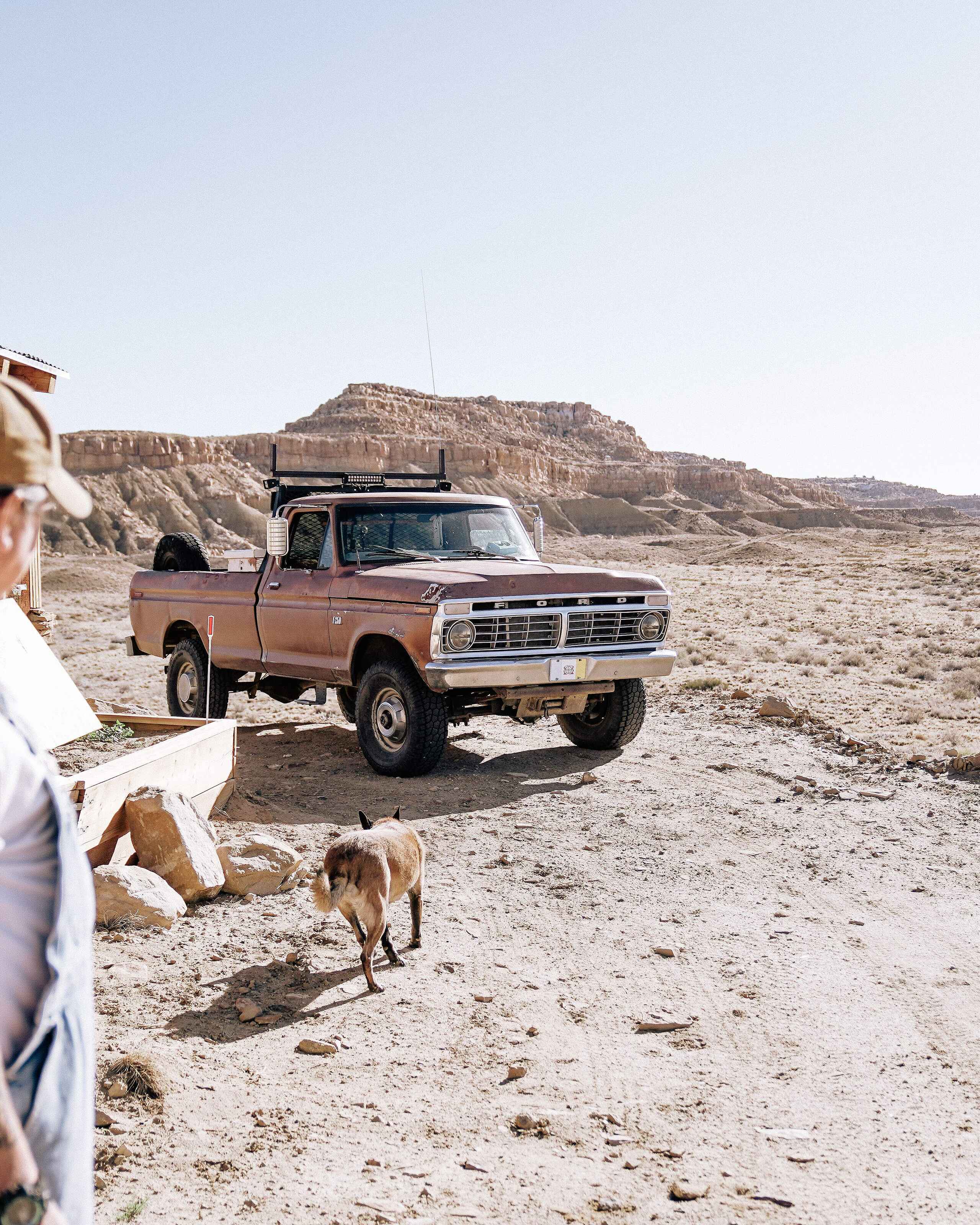Dr. Michael Kotutwa Johnson stands outside his home in the high desert landscape of the Hopi Nation