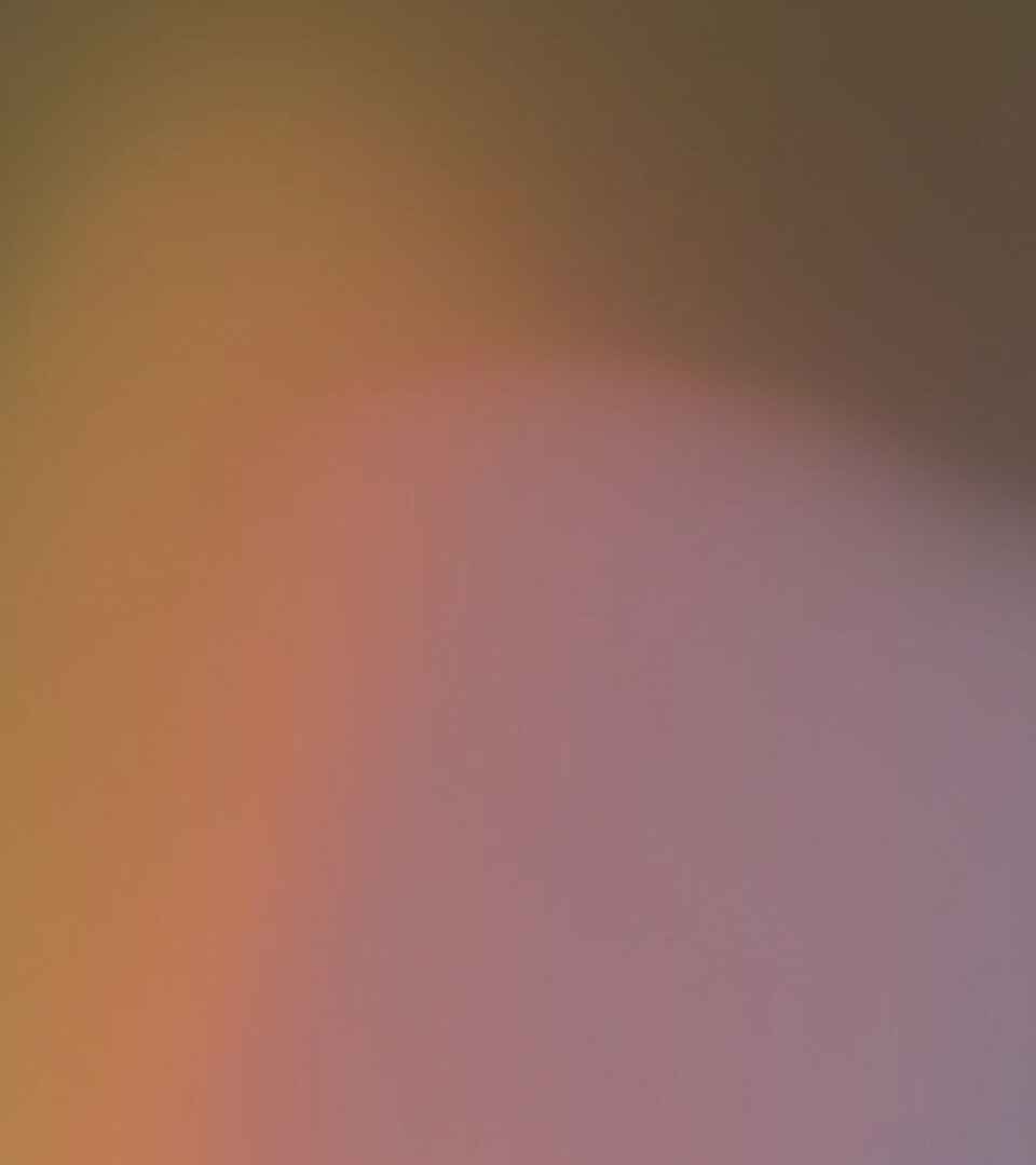 Gradient background transitioning from warm golden tones to cool purple hues