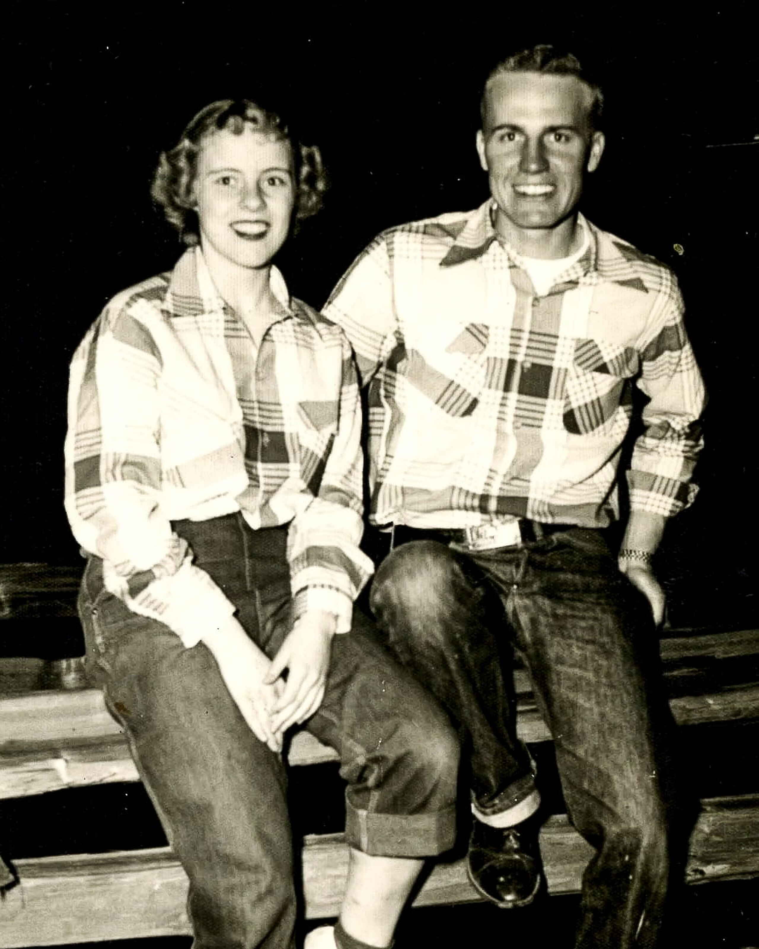 Zakarison family members in matching plaid shirts posing together on wooden steps